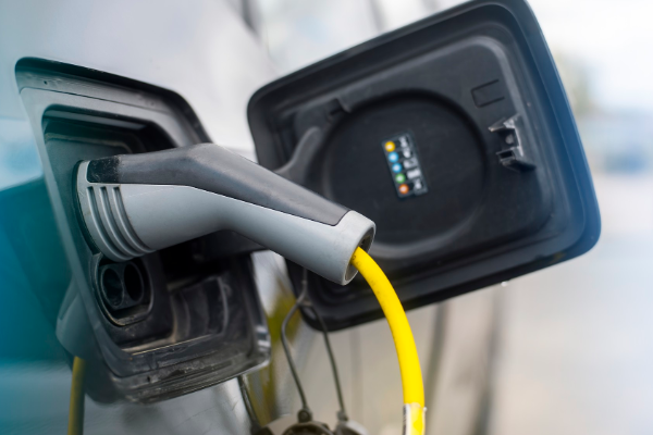 Plugged in charger into an electric car at charge station