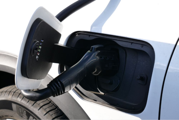 Close-up view of an electric vehicle charging with a focus on the connector and charging port